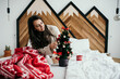 Fashionable woman in a cozy room in Christmas mood