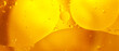 Gold Oil bubbles close up. circles of orange water macro. abstract shiny yellow background