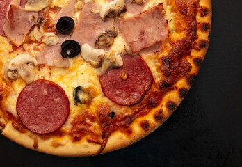 Poster - Pizza with sausage and mushrooms on a black background