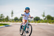 © Volodymyr - Child in safety helmet riding bike. Boy riding bike wearing a helmet outside. Child in safety helmet riding bike. Little kid boy learns to ride a bike. Kid on bicycle. Happy child in helmet riding a