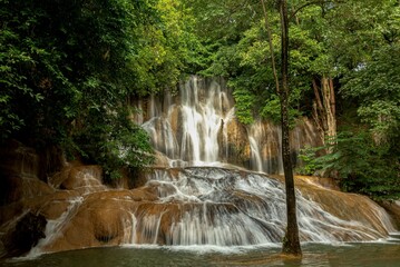 Poster - Scenic view of the Saiyok Yai waterfall in an evergreen forest in Thailand