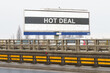 © Dzmitry - On the highway there is an advertising billboard with the image and the inscription - HOT DEAL