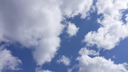 Wall Mural - real time 4k stock video footage of clear sunny morning blue sky with flying fast white fluffy huge 