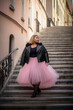 Generative AI illustration of plus size beautiful and happy black woman walking down the street with a pink tulle skirt