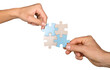 © BillionPhotos.com - Closeup on Hands Combining Puzzle Pieces Together