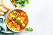 Minestrone soup, italian vegetable soup with smoked sausages, Top view with copy space.