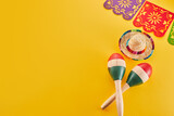 Fototapeta Kawa jest smaczna - Cinco de Mayo holiday background. Maracas, cactus and hat on yellow background.