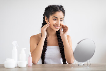 Wall Mural - Beauty Concept. Attractive Young Indian Woman Looking At Mirror At Home