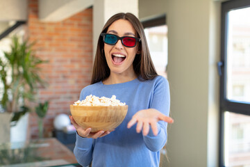 Poster - smiling happily and offering or showing a concept. popcorns and movie concept