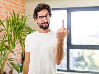 Wall Mural - young adult crazy man with expressive pose at a modern house interior