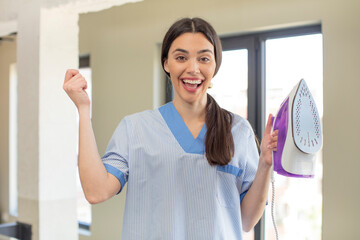 Wall Mural - pretty young model feeling shocked,laughing and celebrating success. housekeeper and laundry concept