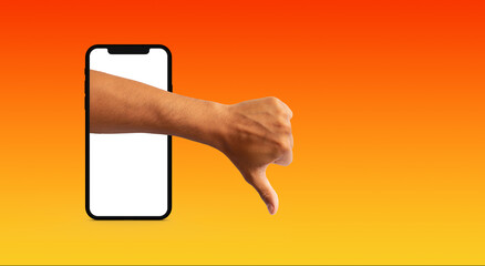 hand of a man with thumb down sticking out of a cell phone on orange background