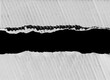 © naiauss - Ripped paper on black background, empty space for text.