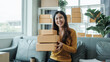 © Phushutter - Young pretty Asian female influencer small businesses SME owners female entrepreneurs working on receipt box and check online orders, sitting on sofa of home online business.