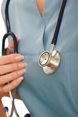 Wall Mural - Close up of stethoscope on a female healthcare professional in scrubs