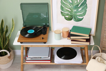 Wall Mural - Stylish turntable with vinyl record on console table in cozy room