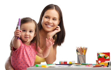 happy young mother and daughter painting