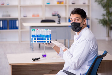  Young male chemist working at the lab