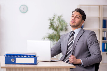 Young male employee working in the office