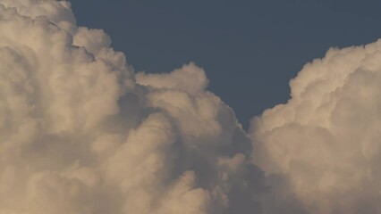 Wall Mural - Cloud closeup Time lapse video. Large, detailed clouds captured from a distance with high-quality cameras and lenses.