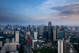 Fototapeta Londyn - aerial shoot of Jakarta skyline during the golden hour. Jakarta is the capital city of indonesia that also one of the most populated city in the world.