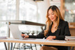 © ArLawKa - Businesswoman working at office with laptop computer on table Asian female accountant or banker doing calculations The concept of finance and financial economy in the office