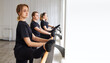 © evafesenuk - Group of women in black sportswear doing stretching at the barre in the fitness room