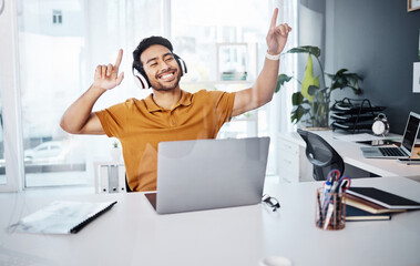 Wall Mural - Business man, dancing and laptop with headphones to listen to music or celebrate success. Happy asian male entrepreneur at desk with a smile and hands for achievement, victory dance or goals