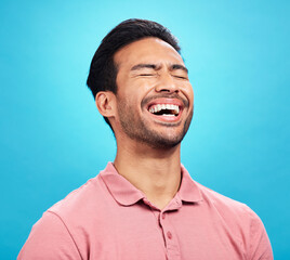 Poster - Laughing, funny comedy and man in studio isolated on a blue background. Comic, humor and male person laugh at joke, laughter and happiness, cheerful and carefree for hilarious smile, excited or emoji