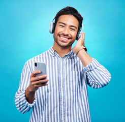 Poster - Happy man in portrait, smartphone and headphones, listen to music with entertainment on blue background. Male person with smile, wireless technology and online audio streaming with radio or podcast