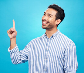 Poster - Point, thinking and man on blue background for news, information and announcement in studio. Advertising, mockup sign and face of excited male pointing for copy space, promotion and showing gesture