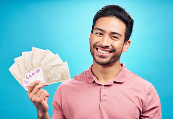 Poster - Happy man in portrait, money fan and cash prize with financial freedom and reward isolated on blue background. Finance, savings and investment payment, male person with economic success in studio