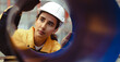 © Nassorn - Latin engineer wears safety helmet work in heavy metal engineering factory. Young female hispanic worker in hardhat hard hat checking production machinery equipment in metalwork manufacturing facility