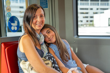 A woman and her daughter on the subway train