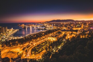 Poster - a city with many lights on a night time sky over water and a large body