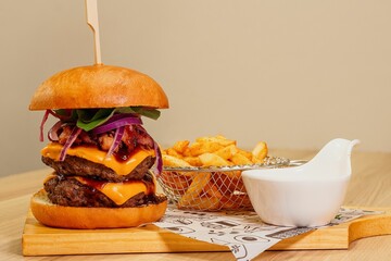 Poster - the burger and french fries are on a wooden board with a fork