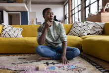 Young Adult Female Reading Tarot Cards At Home