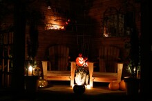 Outdoor Halloween-themed Setting With Wooden Benches And Pumpkins