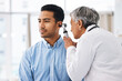 © Sharne T/peopleimages.com - Doctor check patient ear, consultation and healthcare, people at hospital with otolaryngology specialist. Man and senior physician woman with otoscope test for hearing problem and health insurance