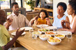 © Monkey Business - Multi-Generation Family Joining Hands And Saying Prayer Before Meal At Home