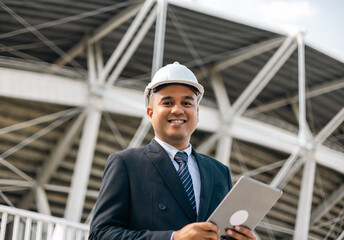 Wall Mural - Businessman manager owner real estate working with digital tablet at modern office building. Cooperation of architect designer. Engineer with safety helmet checking at working construction site