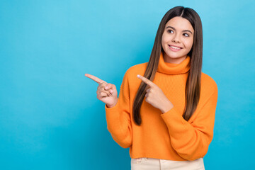 Sticker - Photo of adorable girl with long hairstyle dressed knit turtleneck look at sale directing empty space isolated on blue color background