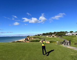 Wall Mural - Golfer strikes with club on golf cours