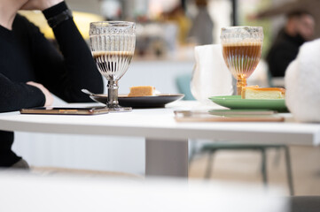 glasses with coffee latte in a street cafe. view of the street cafe table. friends having coffee tog