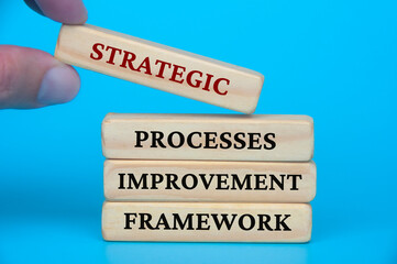 Canvas Print - Strategic process improvement framework text on wooden blocks. Business culture and Operational excellence concept