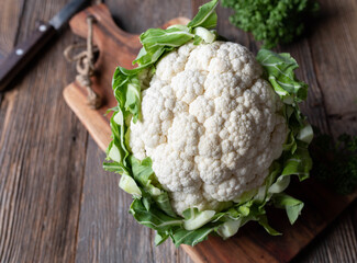 Wall Mural - Cauliflower with leaves on wooden table