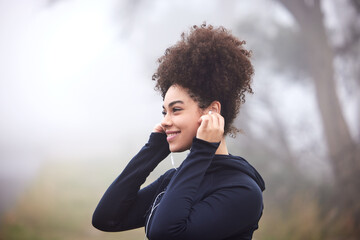 Poster - Playlist loaded. Ready to go. an attractive young female athlete listening to music outside on a foggy morning.