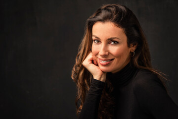 Wall Mural - Beautiful brunette haired woman studio portrait against at isolated background