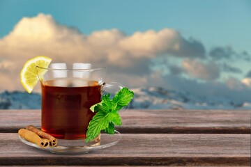 Wall Mural - Tasty hot tea in cup in the sky background.