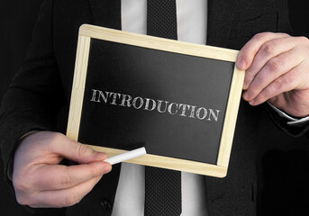 Aufkleber - A businessman holds up a chalkboard with text Introduction